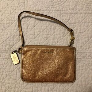 Coach gold shimmer wristlet.